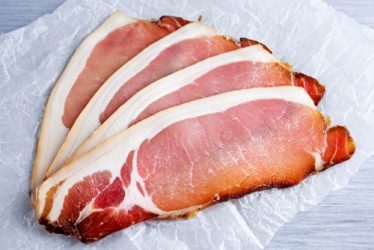 Raw,Beer,Bacon,Slices,On,Crumpled,Paper,Which,Herbs back bacon